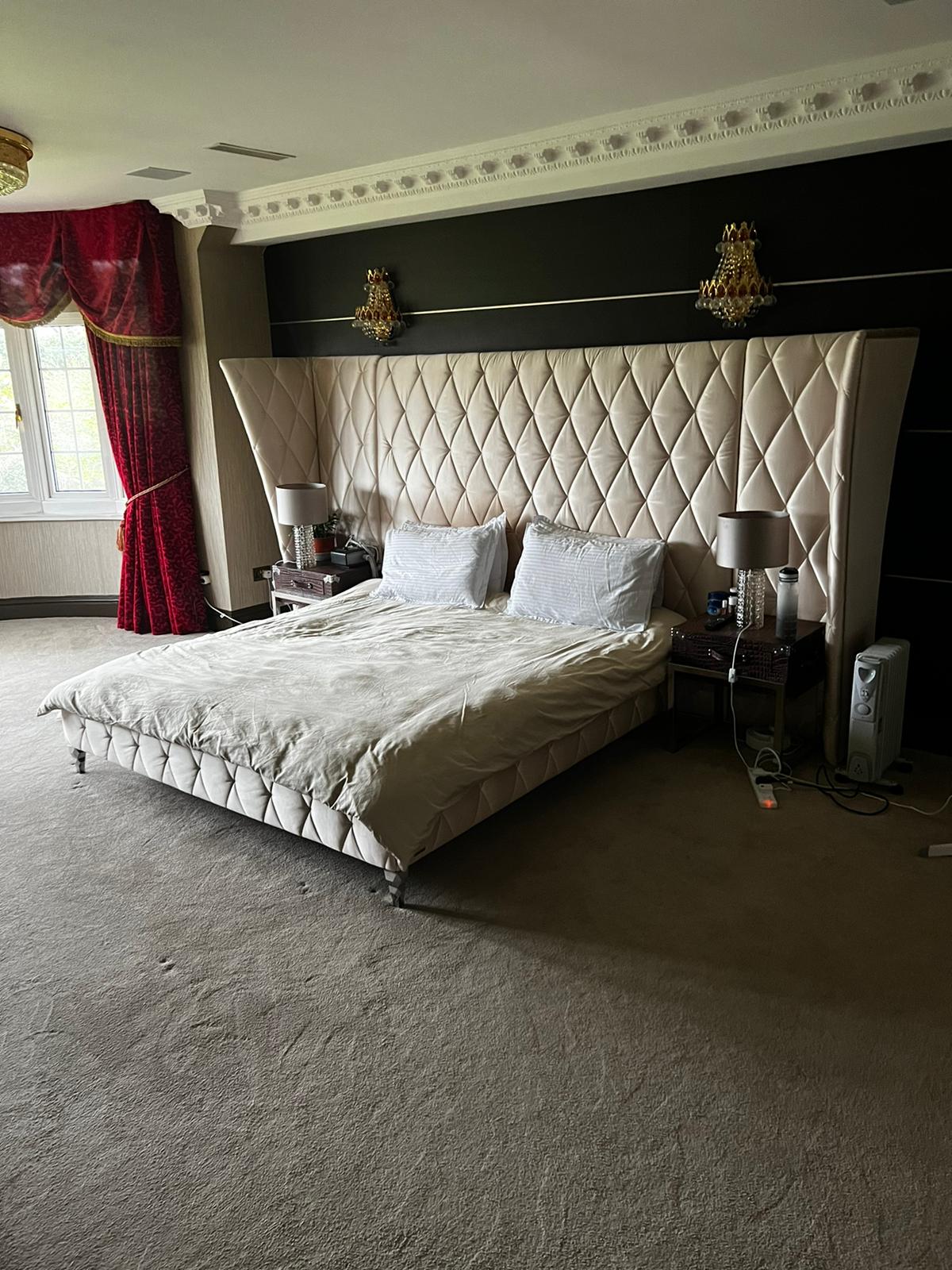 Large upholstered bed and bedroom furniture prepared for relocation