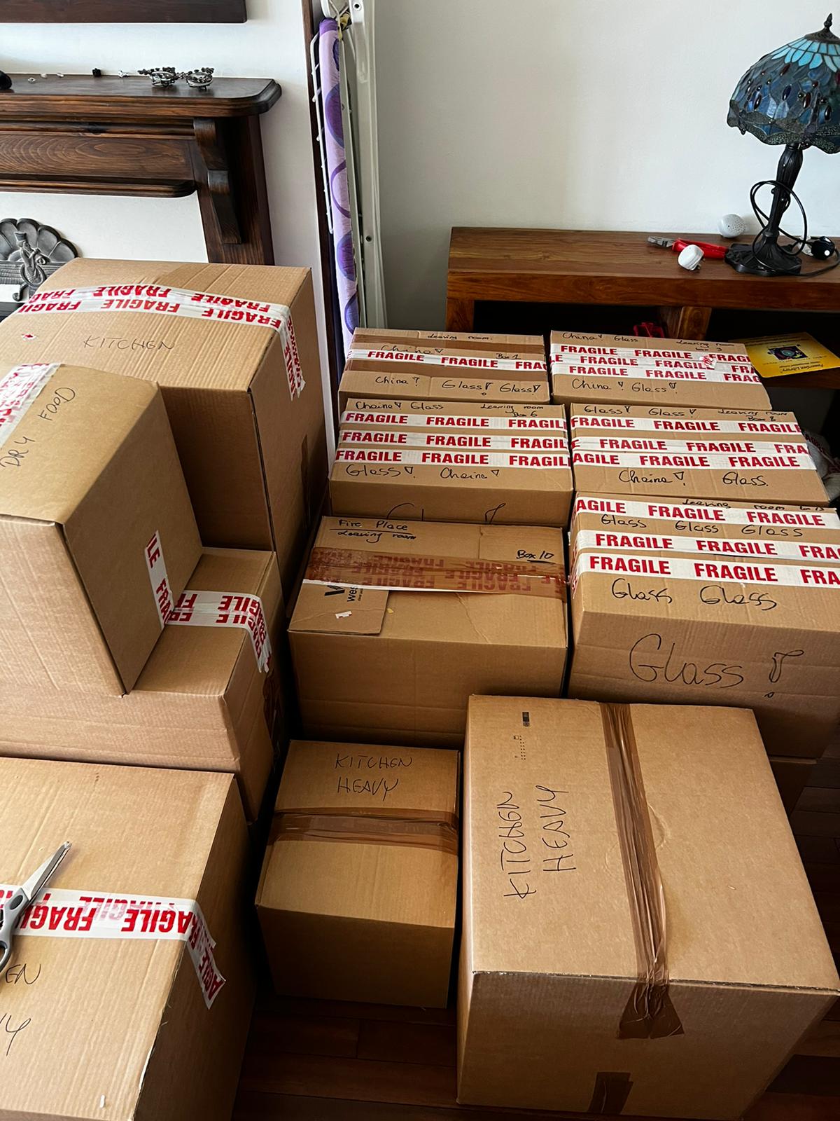 Fragile boxes labelled by room ready for a UK house move