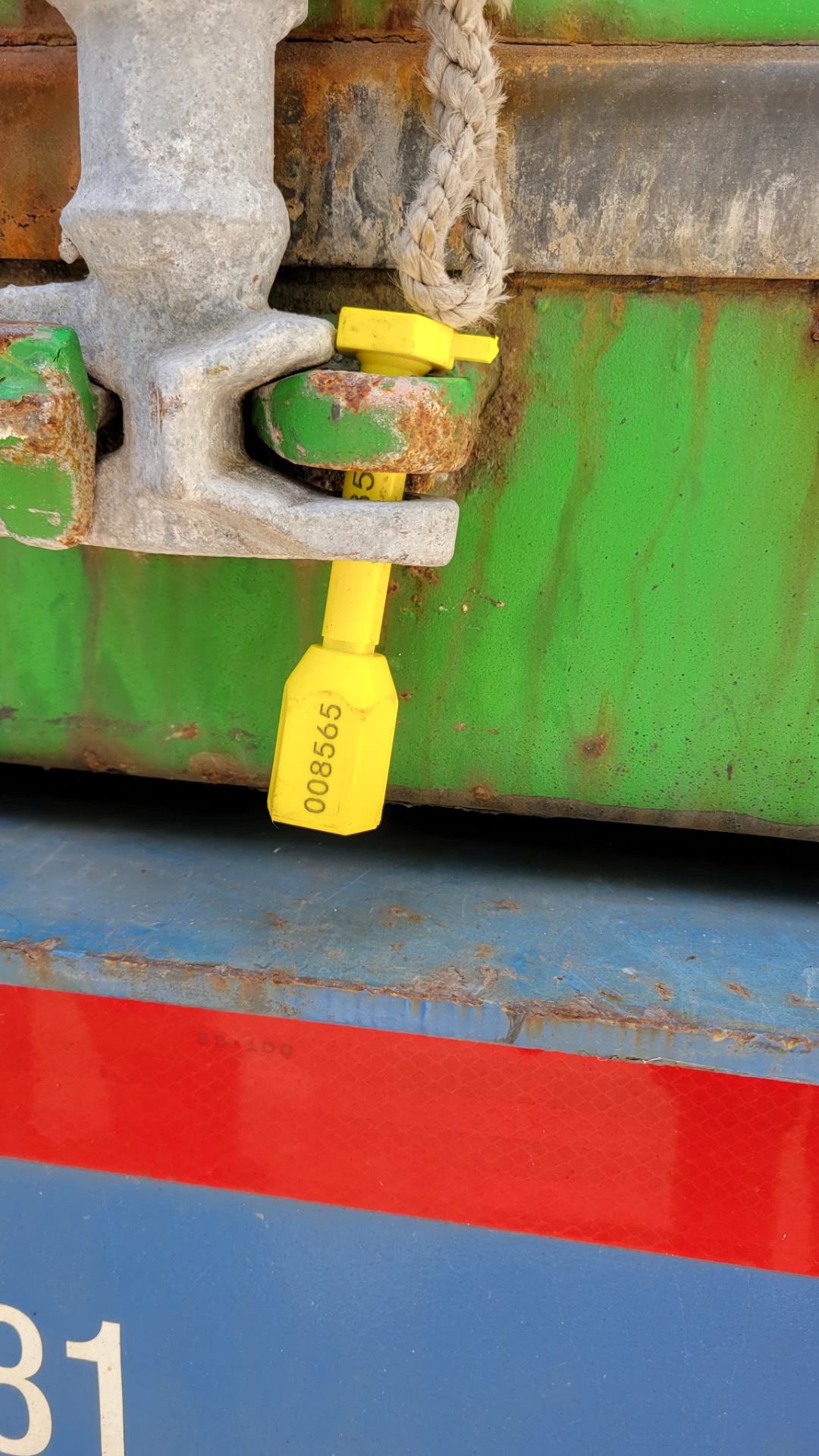Yellow numbered customs seal fastened to a sealed shipping container by Dimond Movers